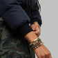 Close-up shot of plush brown faux fur trim and structured hood on dark navy insulated puffer jacket