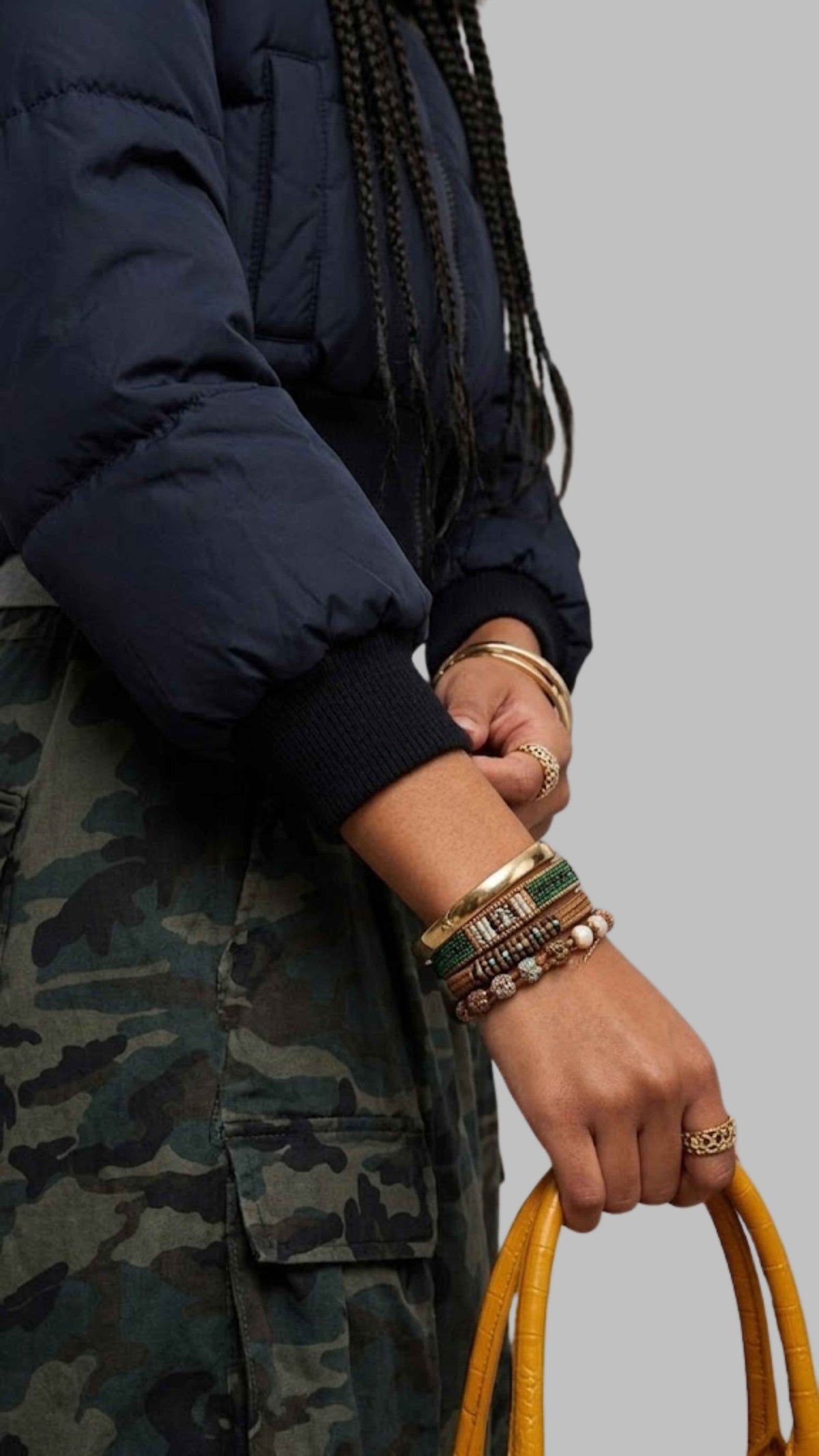 Close-up shot of plush brown faux fur trim and structured hood on dark navy insulated puffer jacket