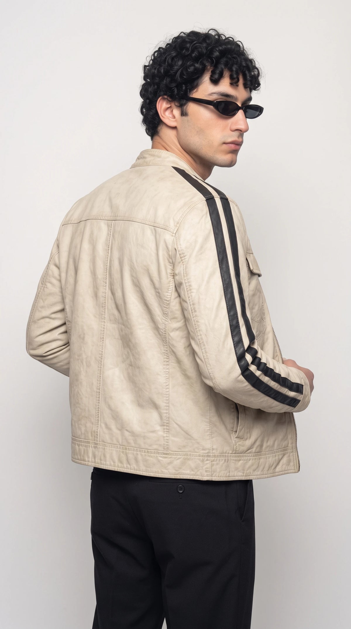 Ivory genuine leather biker jacket featuring two horizontal flap chest pockets, a snap-fastened band collar, a full-length metal zipper and precise tonal stitching, combining practical utility details with a clean high-fashion silhouette.
