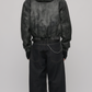 Model wearing a black distressed leather jacket with fur hood styled for a cyber Y2K fashion lookbook.