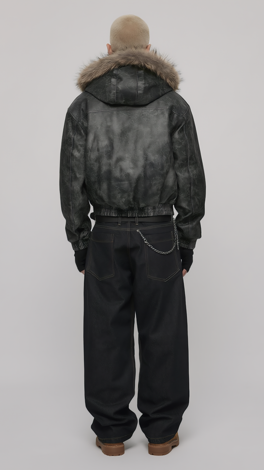 Model wearing a black distressed leather jacket with fur hood styled for a cyber Y2K fashion lookbook.