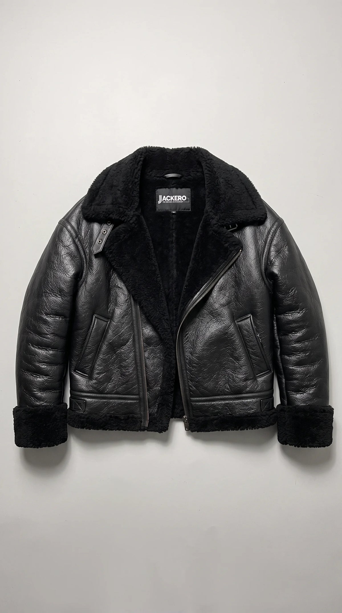 JACKERO black genuine leather aviator flight jacket displayed open to reveal its thick black faux-shearling interior and branded neck label, with plush lapels, matching cuff and hem trim, slanted waist pockets and a sturdy asymmetrical metal zipper.