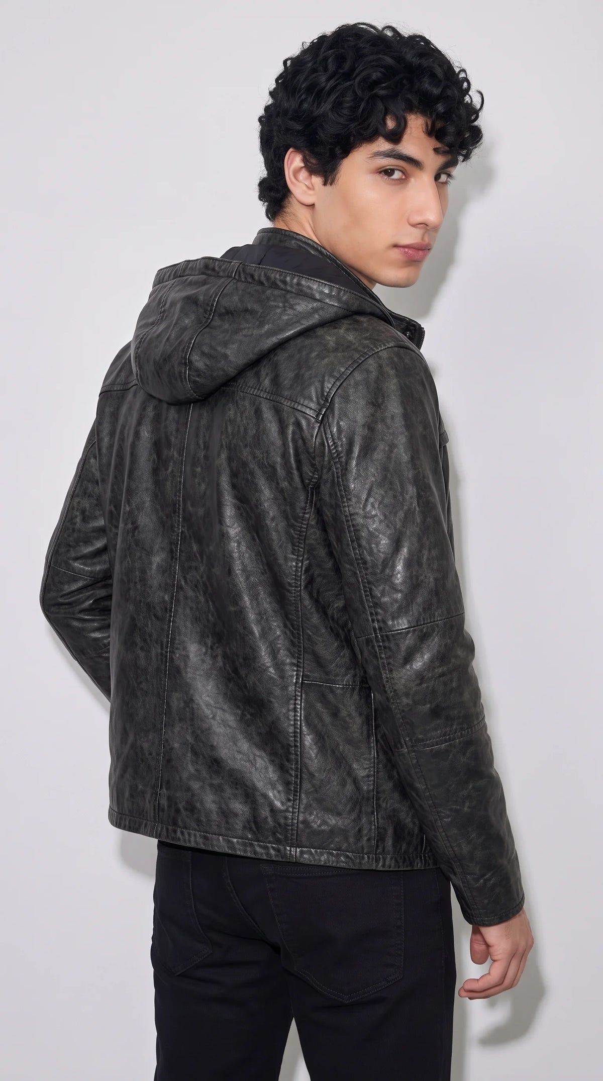 JACKERO black leather hooded jacket featuring a sculpted attached hood, defined shoulder seams, vertical back-panel stitching and a weathered black finish, designed for a confident rugged streetwear wardrobe.