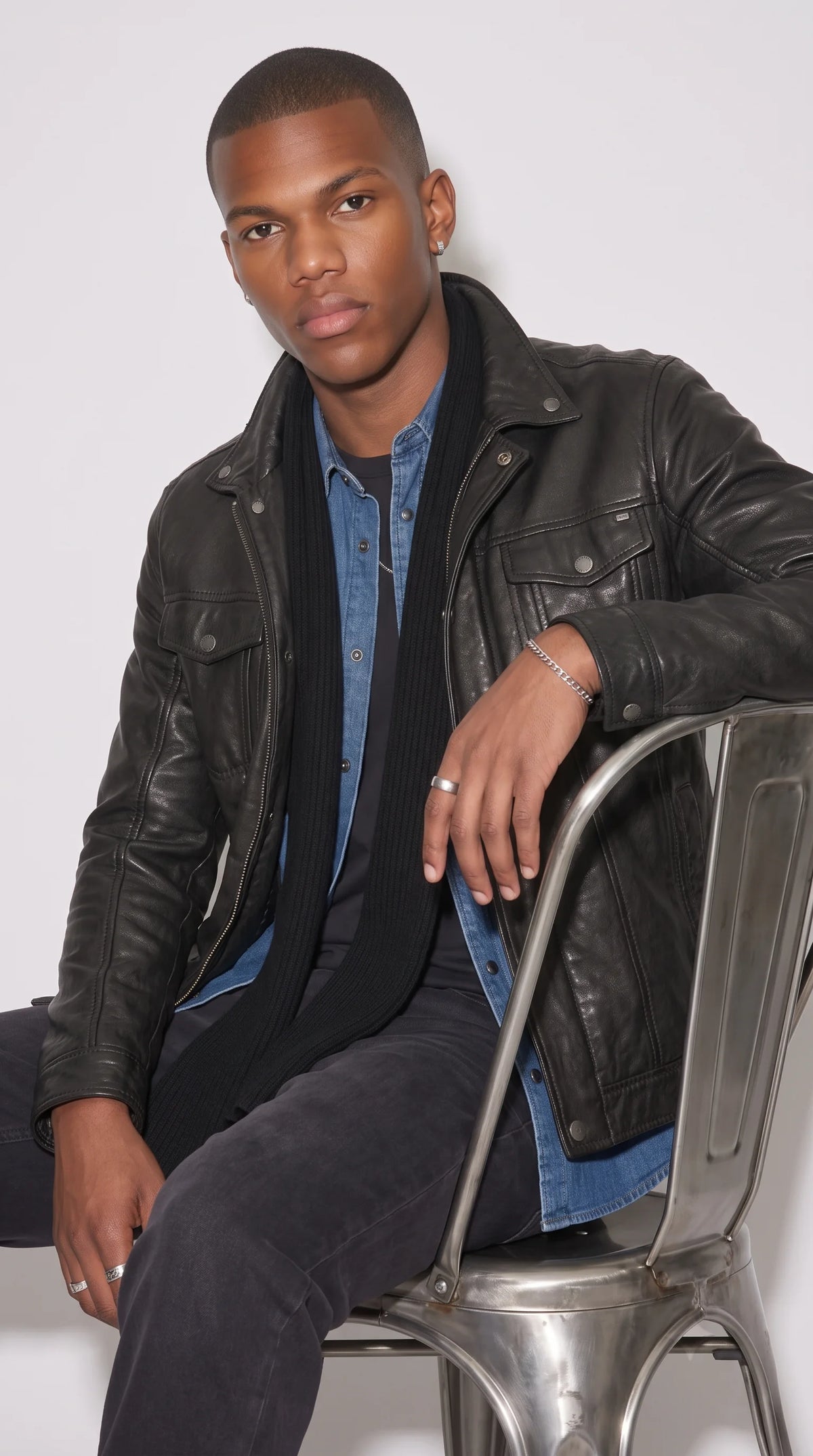 JACKERO black genuine leather trucker jacket with a button-front closure, structured chest flap pockets and discreet lower waist pockets, combining a clean leather finish with practical details for contemporary urban layering.