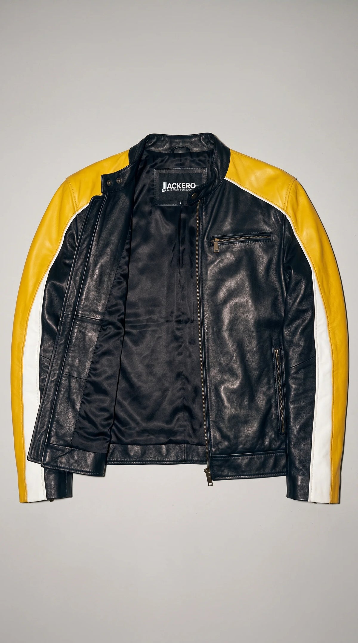 JACKERO black, yellow and white tricolour genuine leather cafe racer jacket displayed open to reveal its smooth black inner lining and branded neck label. The metal front zipper, clean interior finish and bold contrasting sleeve panels highlight the jacket’s motorsport-inspired design, making it a distinctive option for men who appreciate statement leather outerwear with considered detailing.