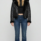 Premium black leather jacket featuring a contrasting white faux shearling collar by Jackero, clean studio front shot.