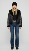 Premium black leather jacket featuring a contrasting white faux shearling collar by Jackero, clean studio front shot.