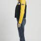 Model wearing a sporty black and yellow genuine leather motorcycle jacket for a sleek, modern streetwear aesthetic.