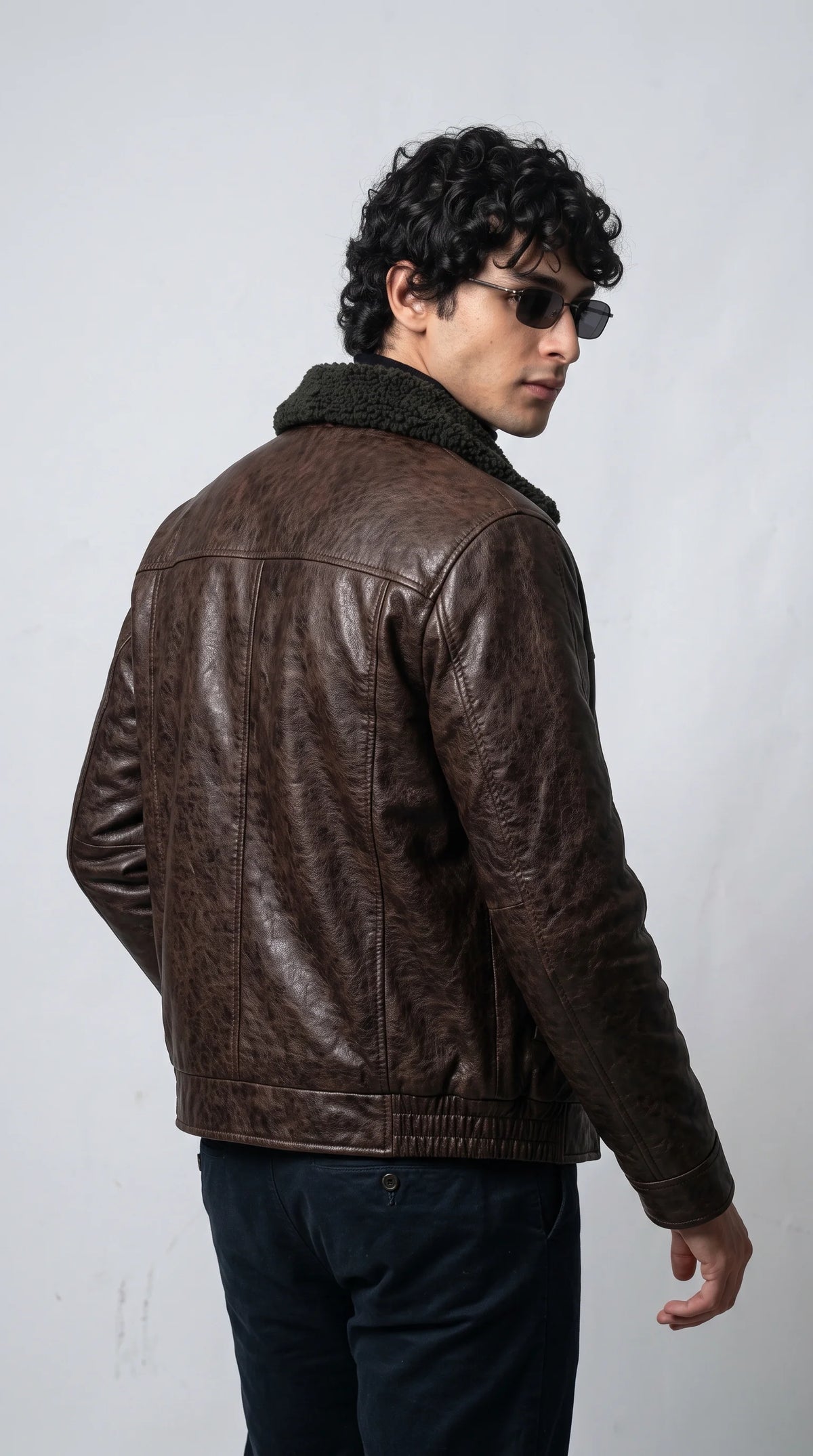 JACKERO distressed espresso brown leather bomber blends vintage flight jacket character with a contrasting black shearling collar for distinctive premium streetwear styling.
