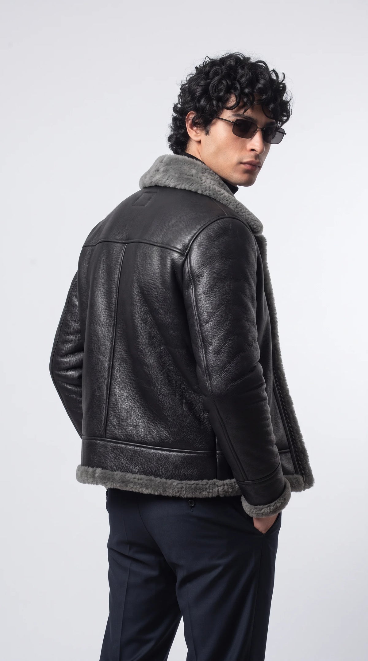 Command the underground fashion scene in the exclusive Jackero black motorcycle jacket, engineered with cozy grey shearling insulation for those who demand bold, street-ready outerwear.
