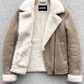 Jackero beige suede jacket with premium white shearling lining displayed beautifully against a minimalist studio backdrop.