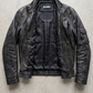 Jackero black distressed leather jacket beautifully showcased against a clean, minimalist studio backdrop.