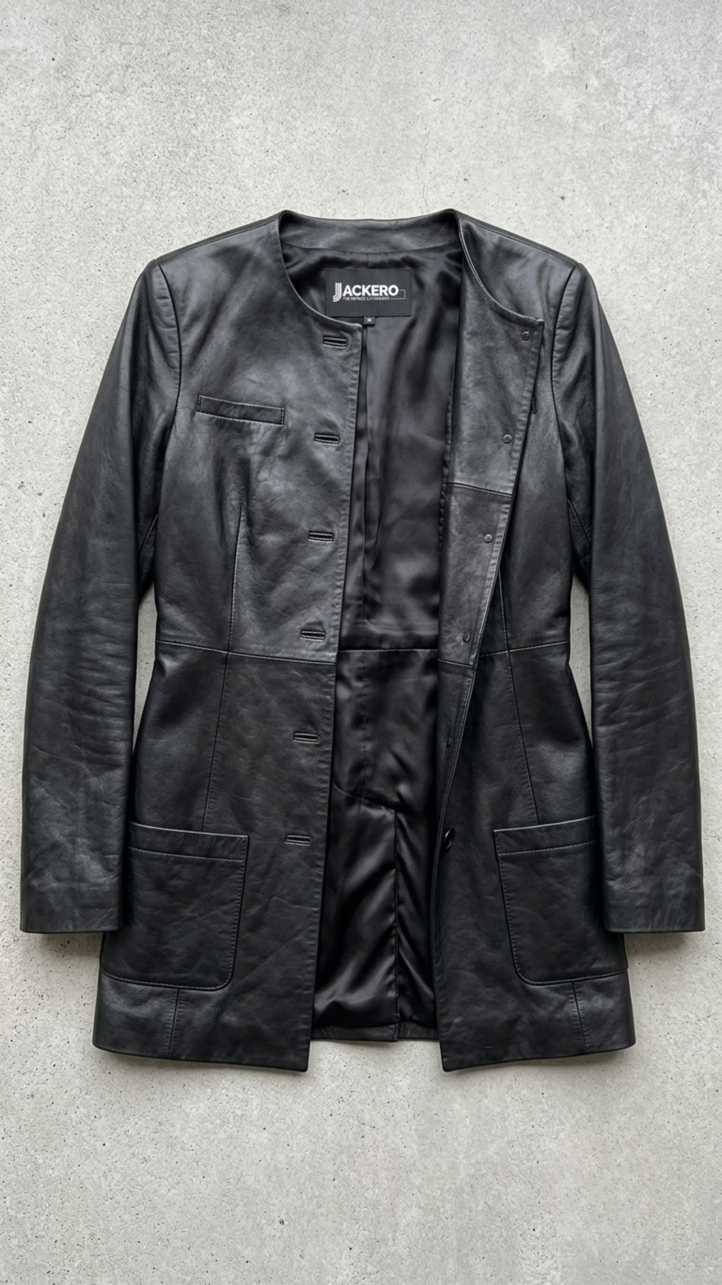 Jackero contemporary long-line black leather trench coat beautifully presented against a clean, professional studio backdrop.