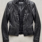 Jackero black leather blazer jacket beautifully presented against a clean, minimalist studio backdrop.