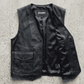 Jackero premium button up black leather vest outerwear beautifully presented against a clean, minimalist studio backdrop.