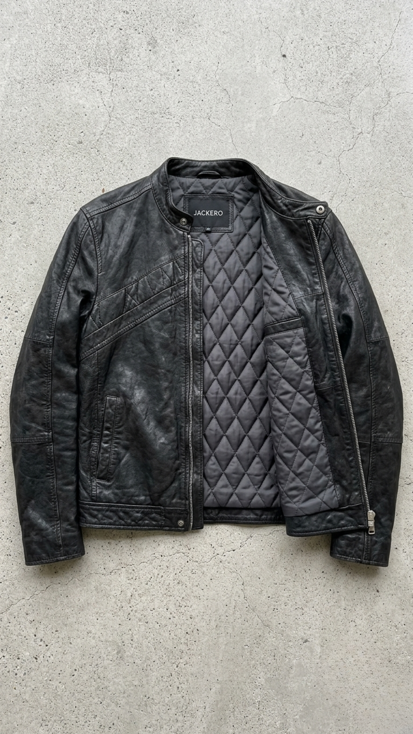 Jackero classic black leather jacket flawlessly presented against a clean, minimalist studio backdrop.
