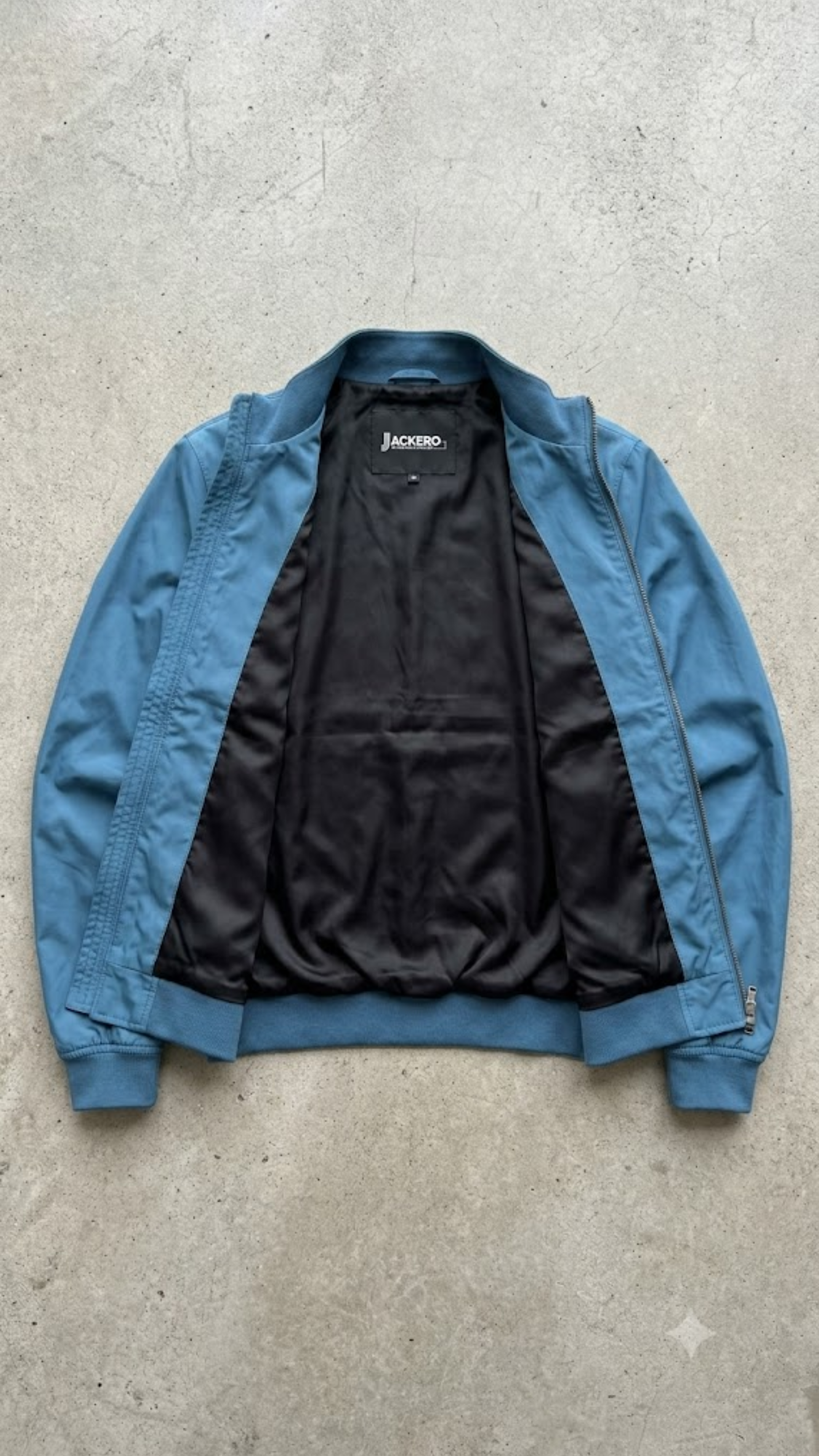 Jackero contemporary cyan silk cotton blend bomber jacket beautifully presented against a clean, minimalist studio backdrop.