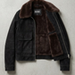 Jackero contemporary dark black suede jacket with dark chocolate shearling beautifully presented against a clean, minimalist studio backdrop.