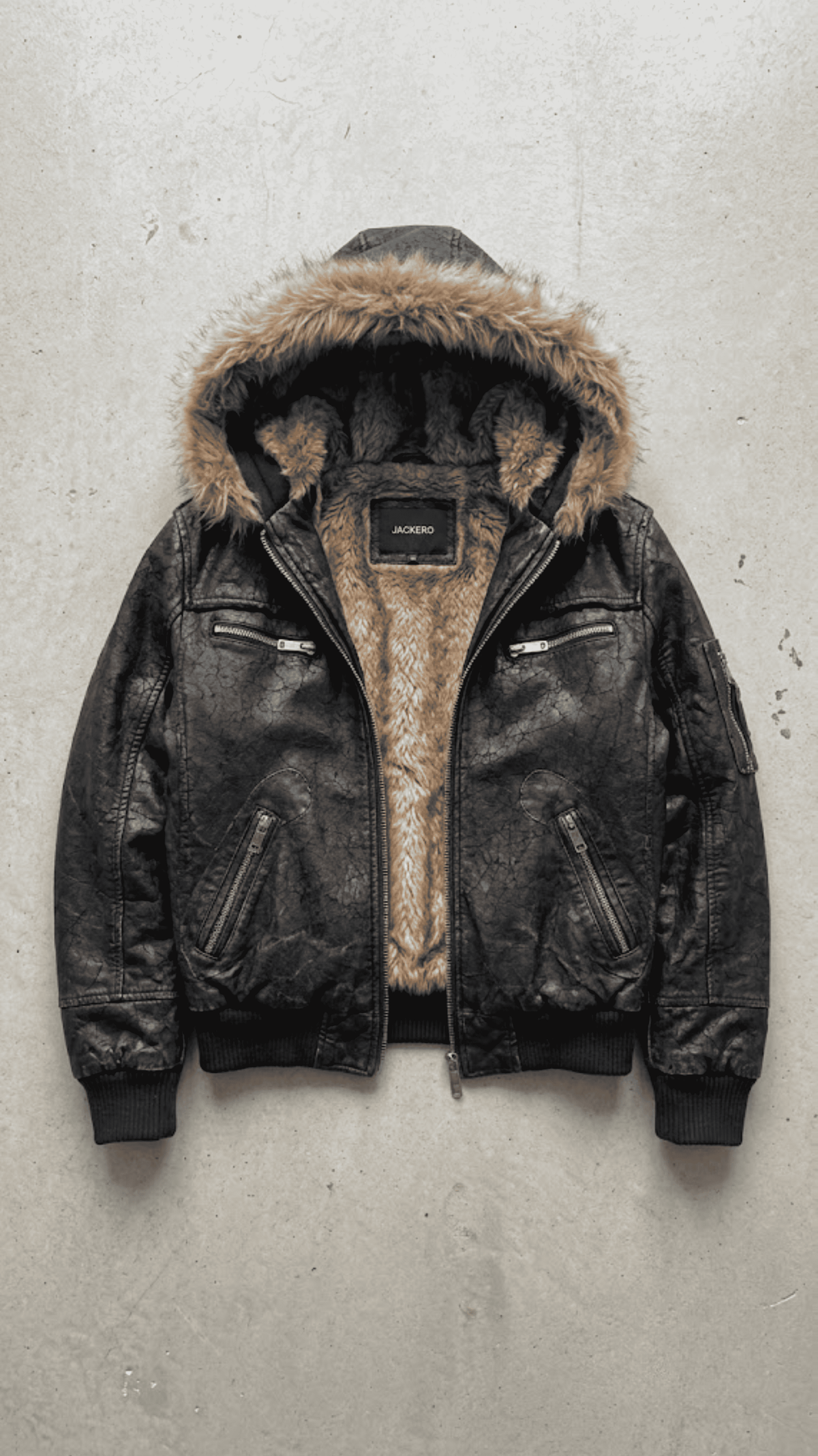 Jackero contemporary Y2K dark black leather baggy oversized jacket with brown fur presented against a clean, minimalist studio backdrop.