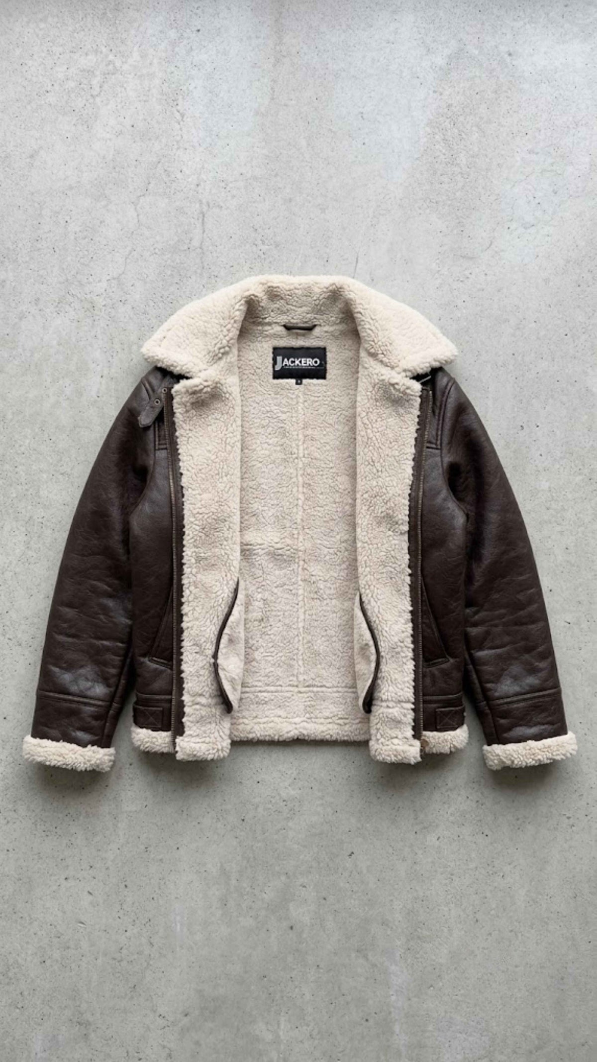Jackero contemporary dark chocolate brown leather baggy oversized jacket with shearling presented against a clean, minimalist studio backdrop.