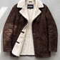 Jackero dark chocolate brown suede coat with premium white shearling details displayed beautifully on a minimalist studio backdrop.