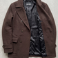 Jackero dark chocolate brown wool overcoat beautifully presented against a clean, minimalist studio backdrop.