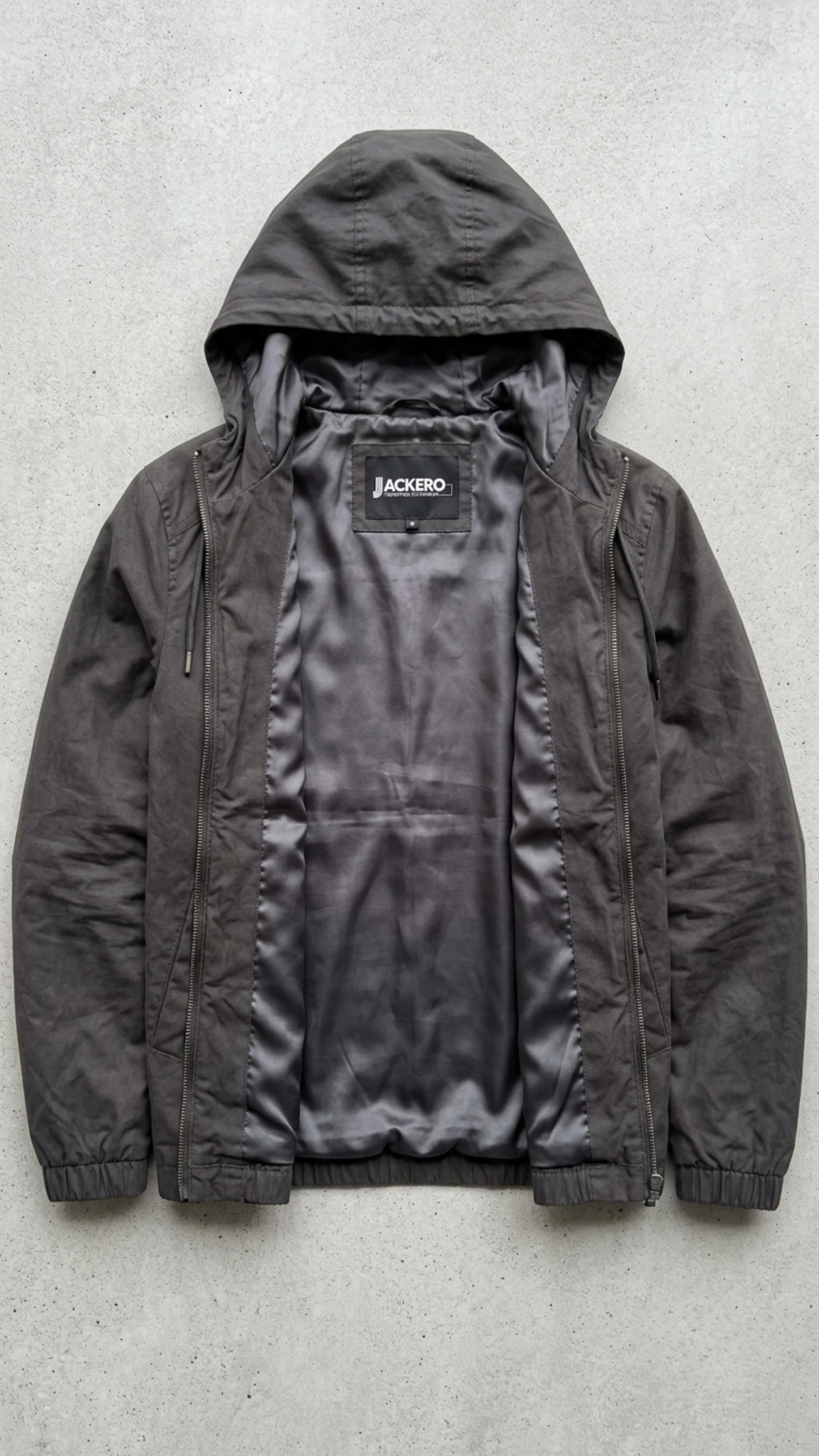 Jackero contemporary dark grey silk cotton hooded outerwear beautifully presented against a clean, minimalist studio backdrop.