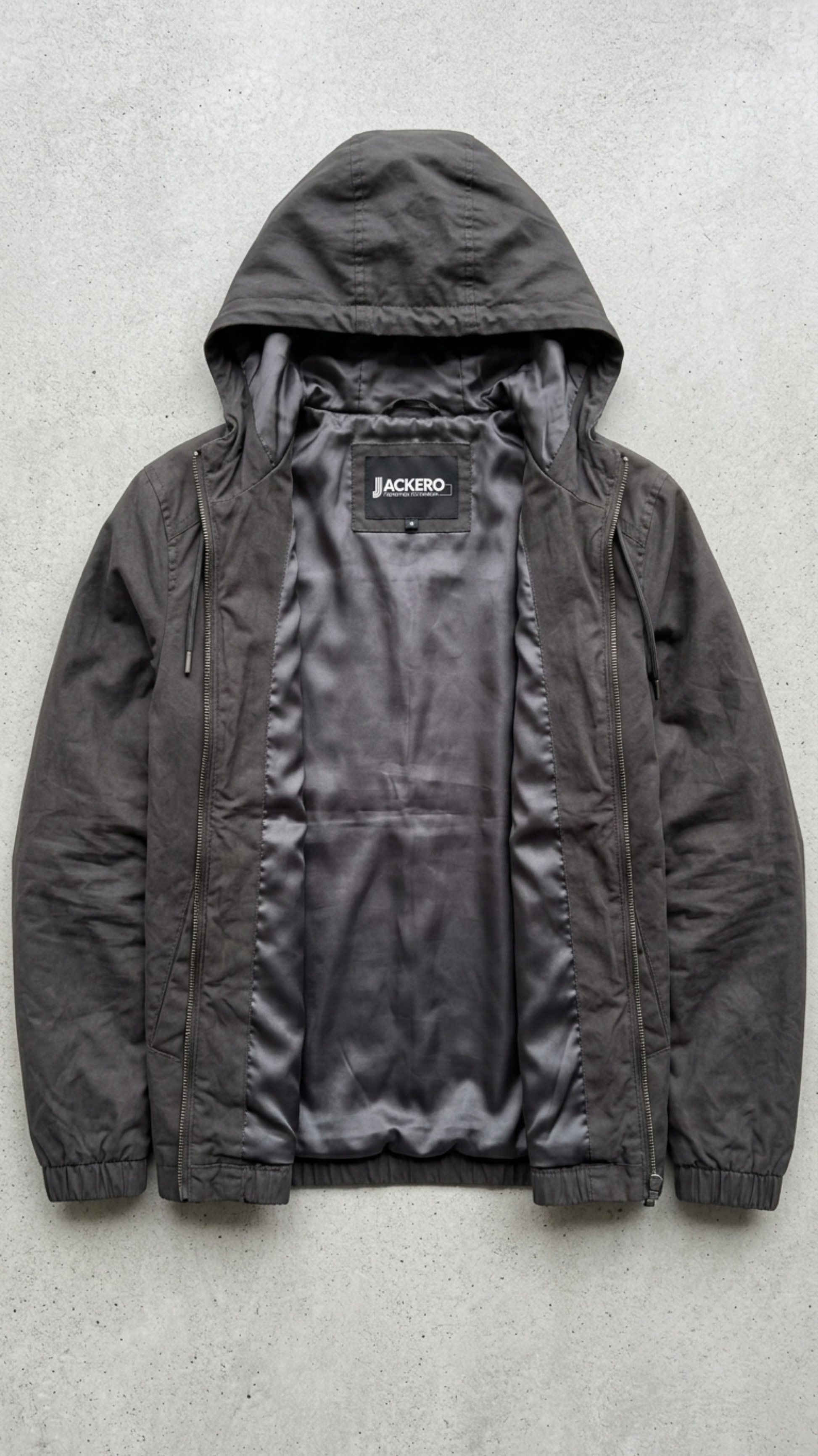 Jackero contemporary dark grey silk cotton hooded outerwear beautifully presented against a clean, minimalist studio backdrop.