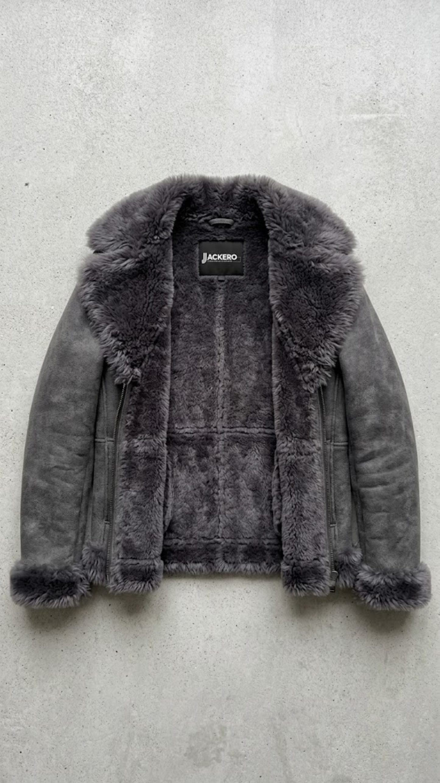 Jackero contemporary dark grey suede jacket with dark grey faux shearling beautifully presented against a clean, minimalist studio backdrop.