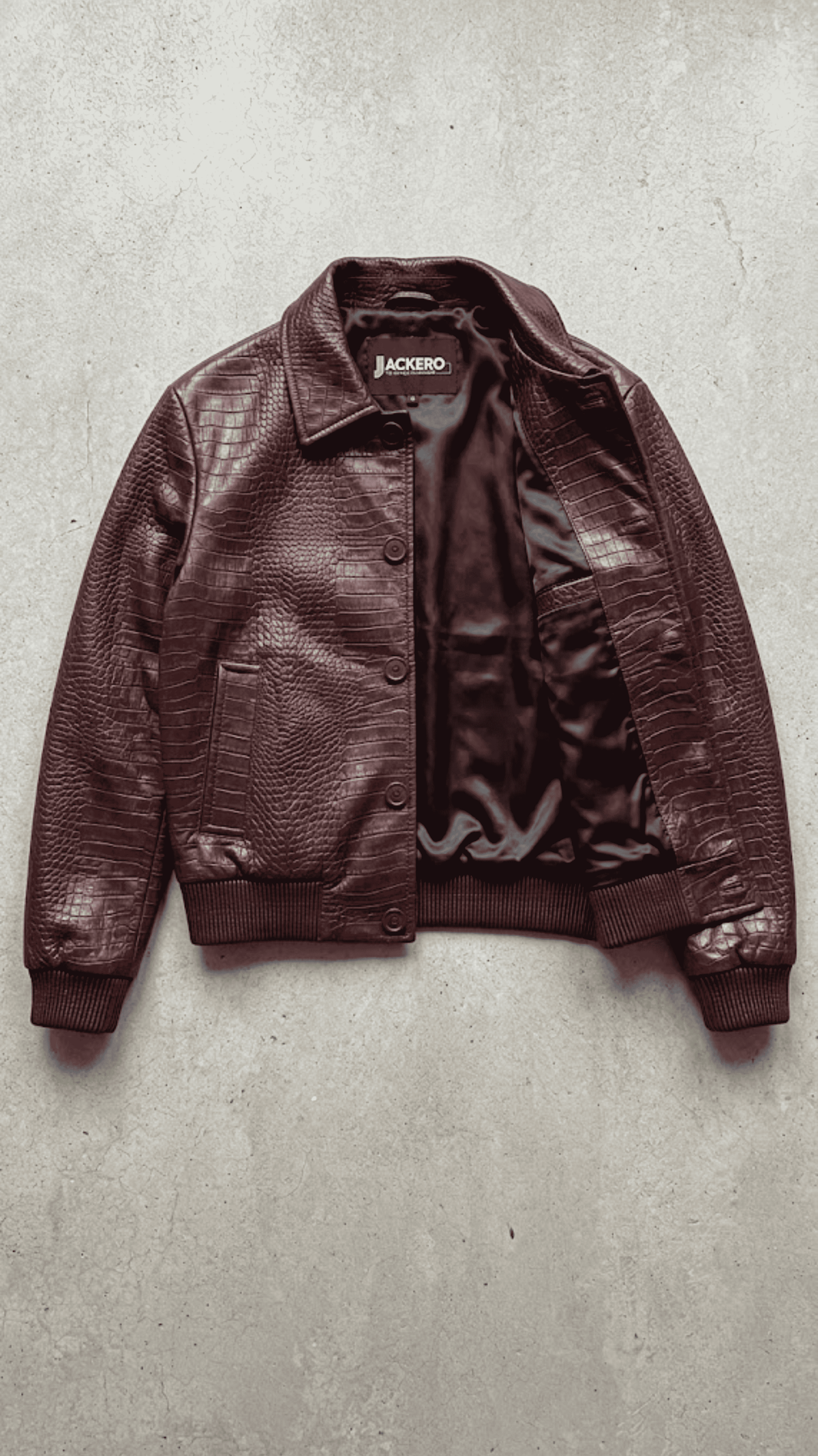 Jackero luxury dark red vine crocodile embossed leather jacket beautifully presented against a clean, minimalist studio backdrop.