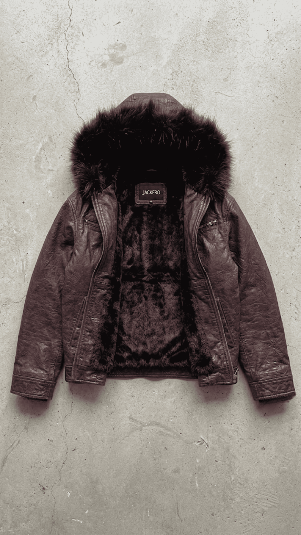 Jackero contemporary dark red vine leather baggy oversized jacket with black fur presented against a clean, minimalist studio backdrop.