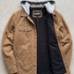 Jackero dark tan work wear hooded jacket beautifully showcased against a clean, minimalist studio backdrop.