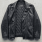 Jackero contemporary darkest black aviator leather baggy oversized jacket presented against a clean, minimalist studio backdrop.
