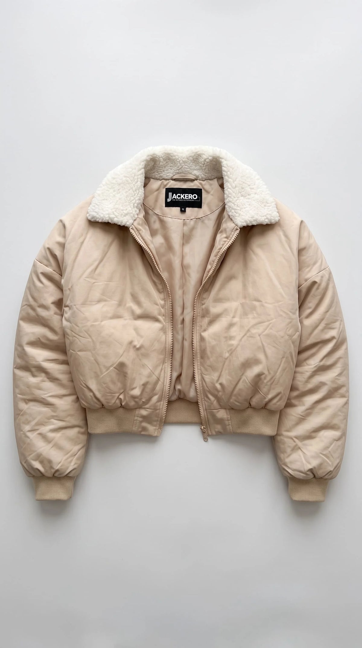 Jackero contemporary light beige silk cotton blend cropped jacket beautifully presented against a clean, minimalist studio backdrop.