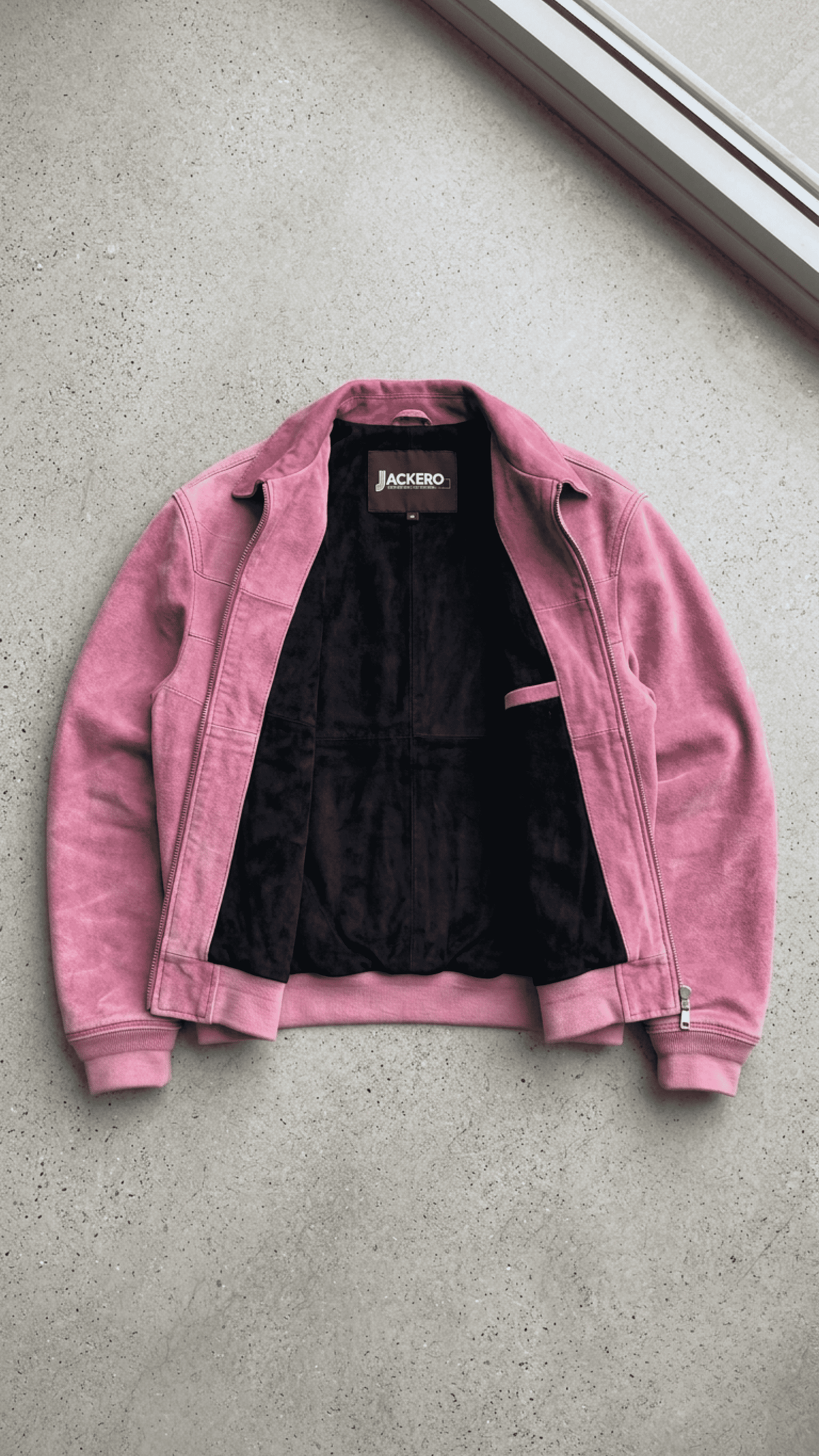 Jackero light pink suede bomber jacket beautifully presented against a clean, minimalist studio backdrop.