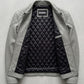 Jackero contemporary men's grey leather jacket beautifully presented against a clean, minimalist studio backdrop.