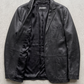 Jackero contemporary black leather blazer jacket perfectly framed against a clean, professional grey studio backdrop.