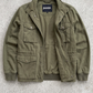 Jackero olive green utility multi-pocket jacket beautifully displayed against a minimalist studio backdrop.