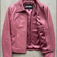Jackero contemporary pink leather fashion jacket beautifully presented against a clean, minimalist studio backdrop.
