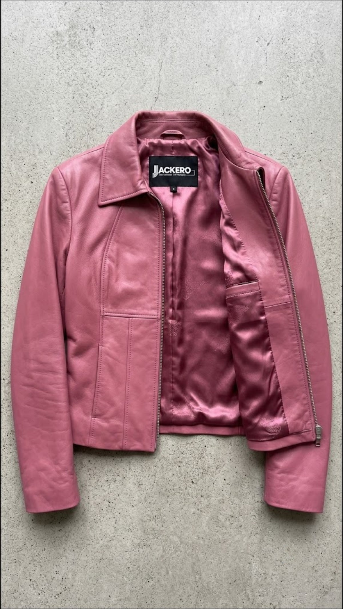 Jackero contemporary pink leather fashion jacket beautifully presented against a clean, minimalist studio backdrop.