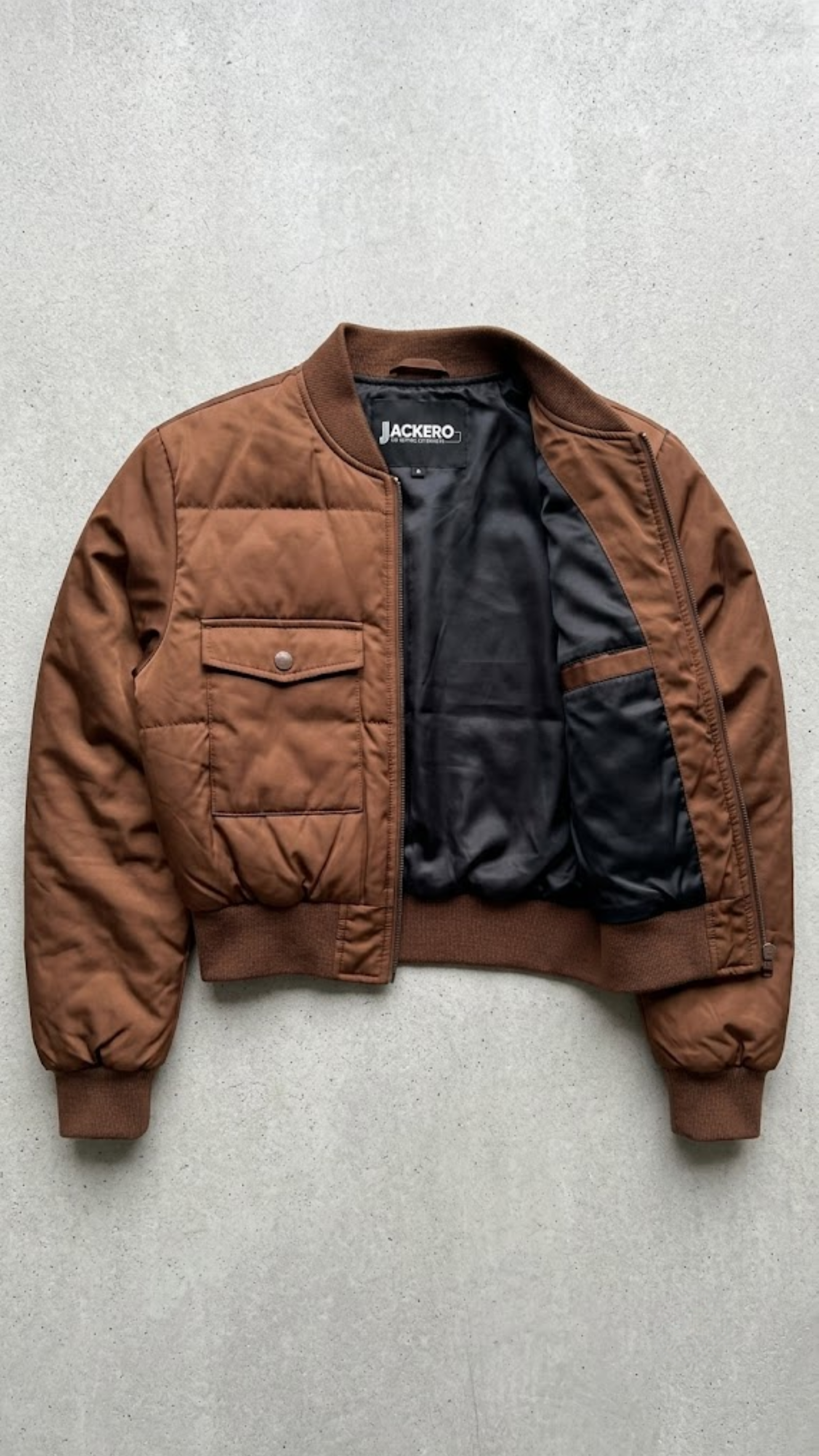 Jackero contemporary tan silk cotton blend jacket beautifully presented against a clean, minimalist studio backdrop.