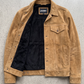 Jackero tan suede jacket beautifully presented against a clean, minimalist studio backdrop.