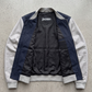 Jackero dark navy blue and grey two-tone cotton jacket perfectly presented against a minimal studio background.