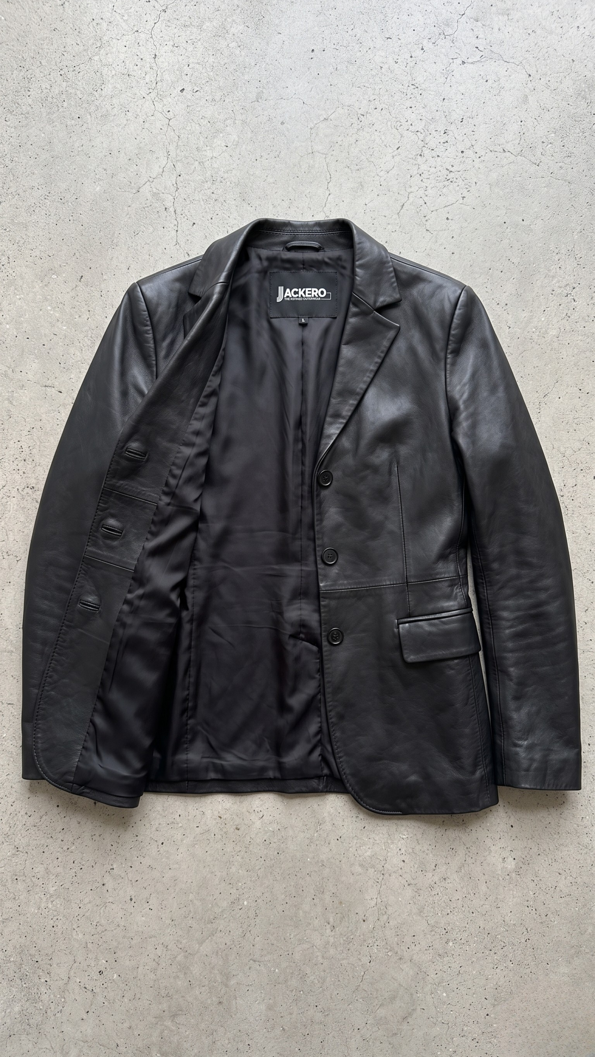 Jackero contemporary women's black leather blazer jacket beautifully presented against a clean, minimalist studio backdrop.