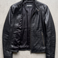 Jackero luxury women's black crocodile embossed leather jacket beautifully presented against a clean, minimalist studio backdrop.