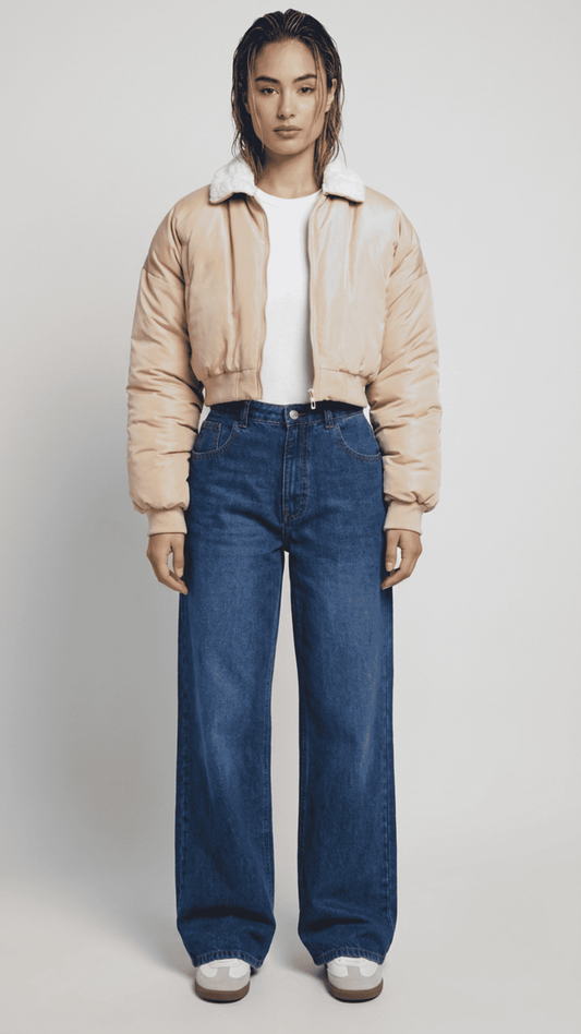 Front full view of premium light beige silk cotton cropped jacket highlighting the clean short waist-length cut and minimalist center zip closure.