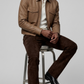 High-street men's lifestyle lookbook shot featuring a contemporary autumn monochrome outfit styled with a sleek beige leather bomber coat.
