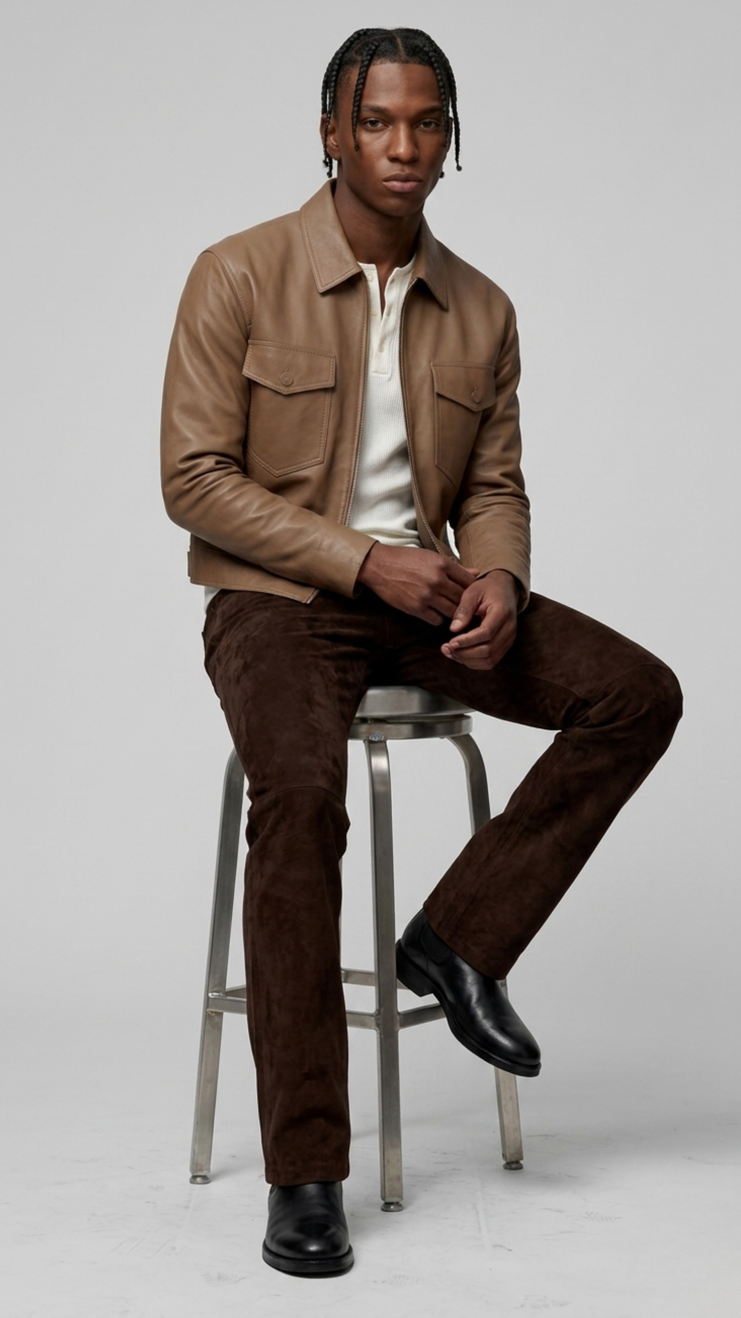 High-street men's lifestyle lookbook shot featuring a contemporary autumn monochrome outfit styled with a sleek beige leather bomber coat.