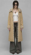Full-length front view of women wearing a light yellow cotton long over coat with structured front button closures.