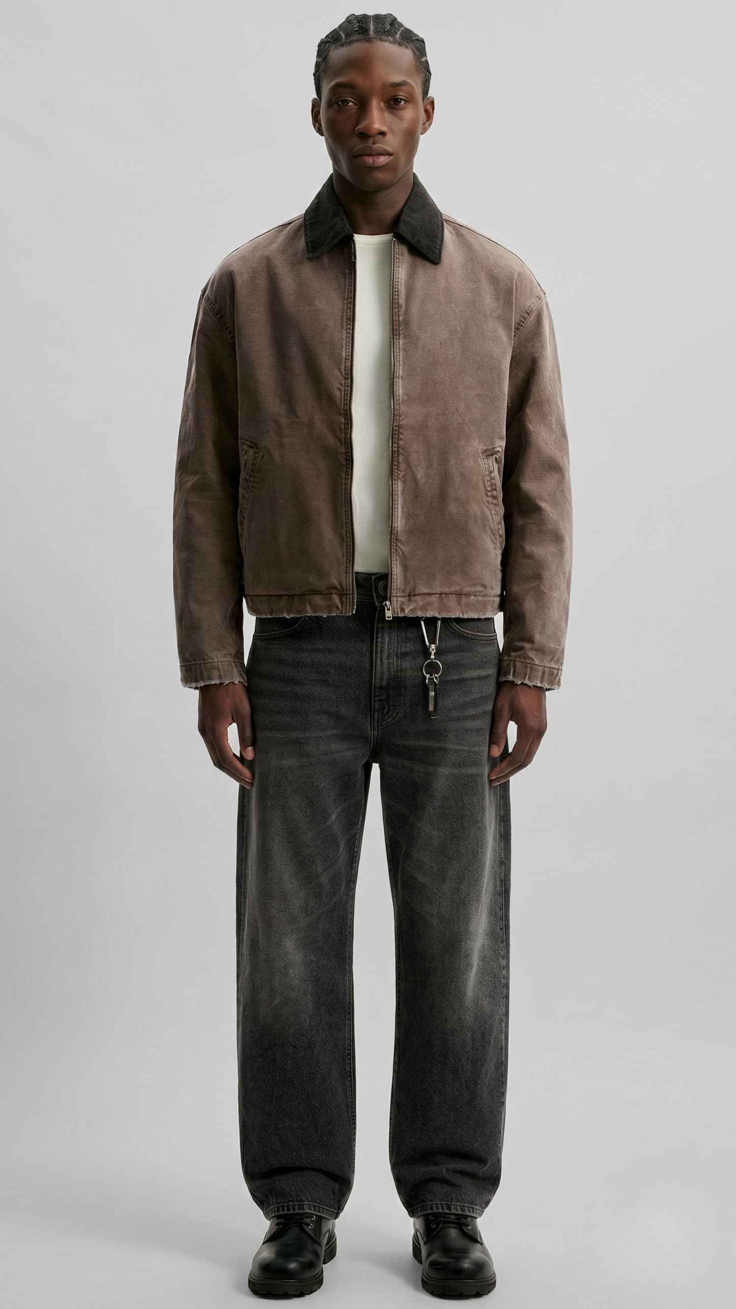 a minimalist brown cotton canvas jacket featuring a clean structured collar and button closure.